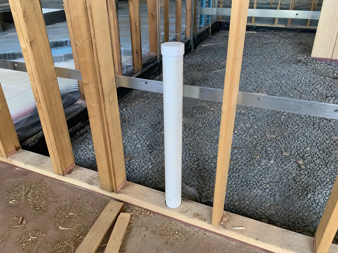 Vent piping and membrane laid in gravel before a slab pour on a Los Angeles construction site