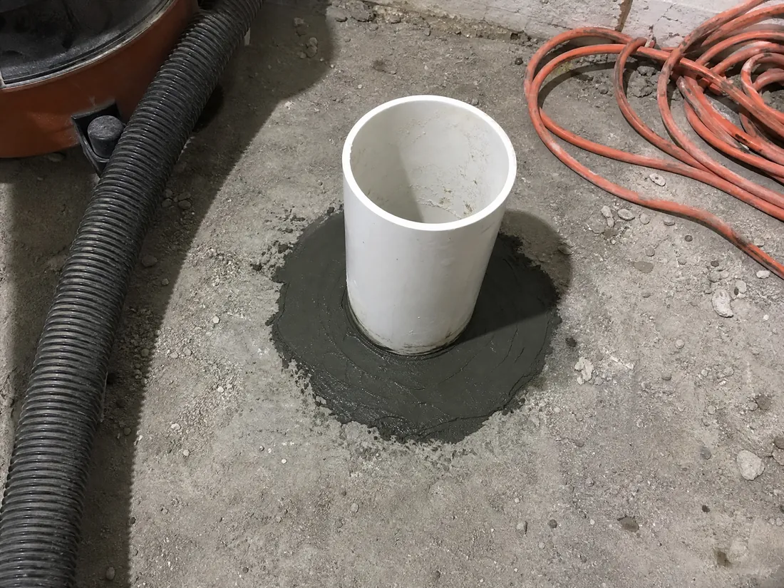 Core drilled suction point and sealed PVC riser for a sub-slab depressurization system in Los Angeles